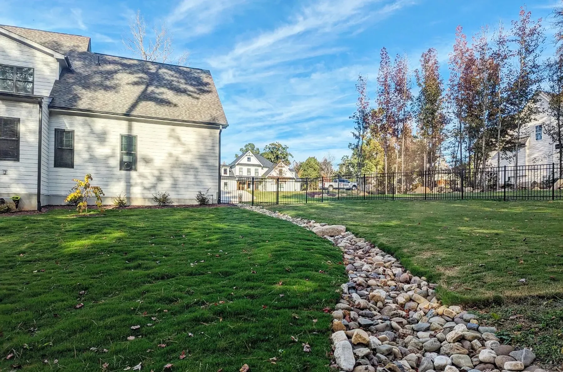 Stone creek bed drainage feature in landscape design