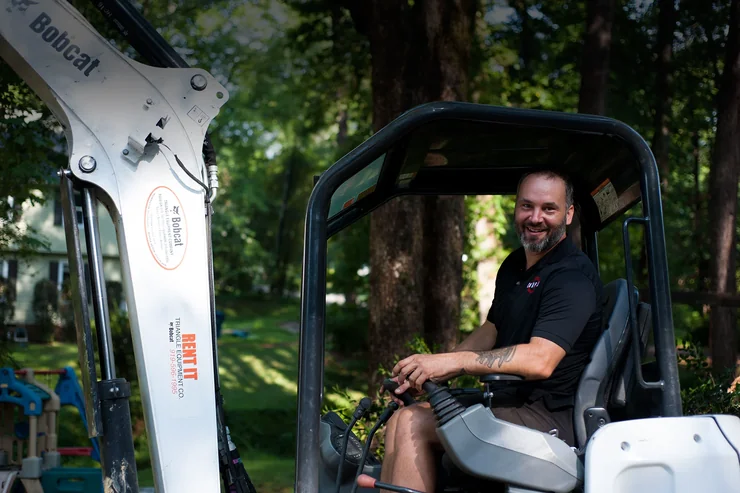 Compact track loader leveling residential yard