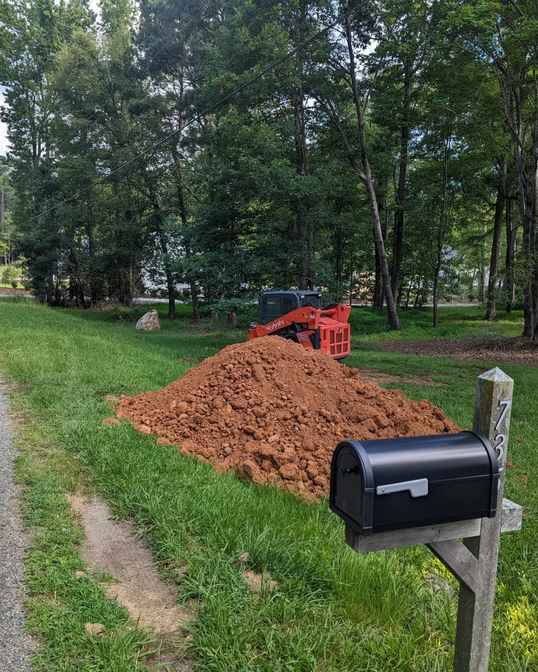 Uneven yard with poor drainage before grading